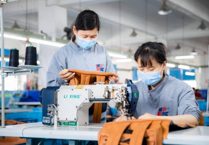 A worker inspecting semi-finished products on the production line.